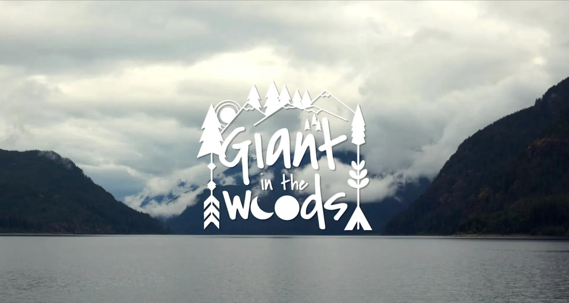 The Giant in the Woods title over a misty lake between forested mountains.