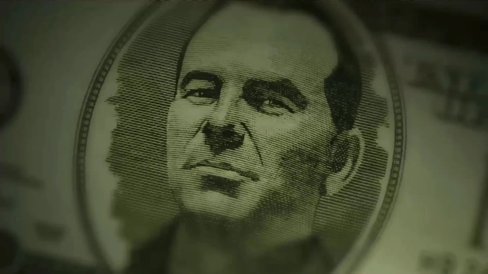 An engraved portrait of a man in the oval frame of a banknote, in green-tinted close-up.