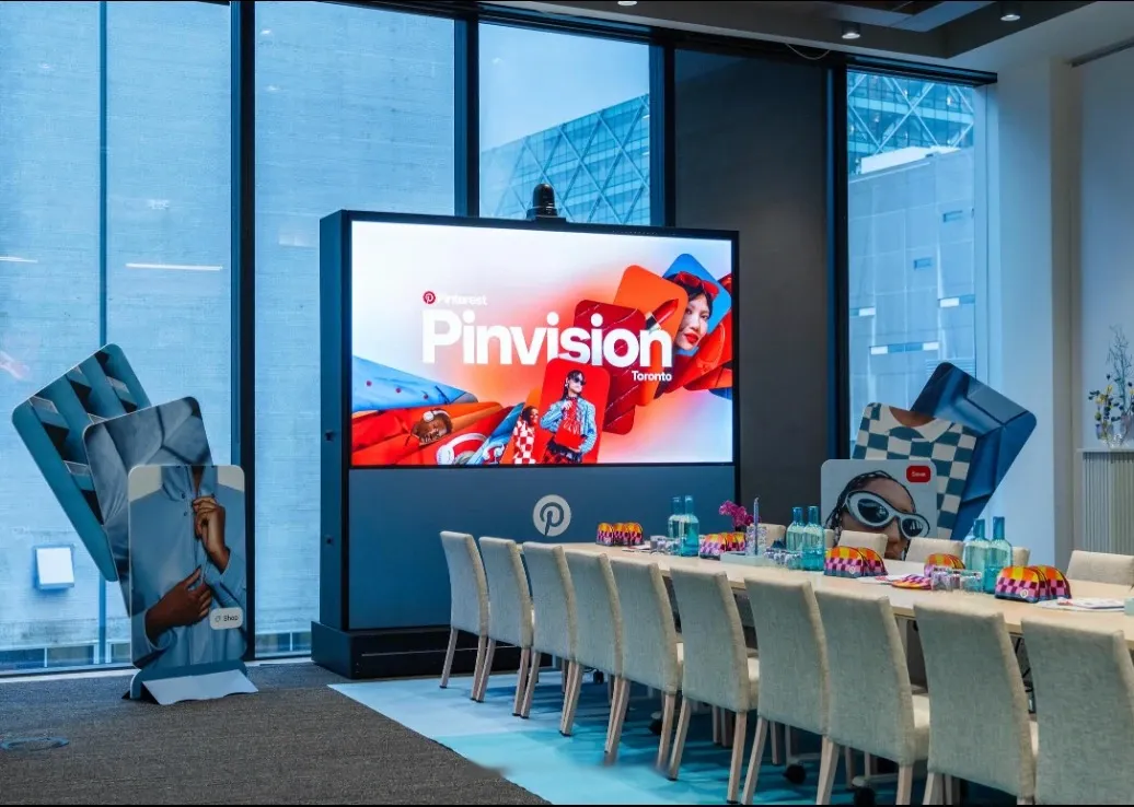 A second boardroom in blue: Pinvision on screen, Pin cut-outs either side, and patterned favours along the table.