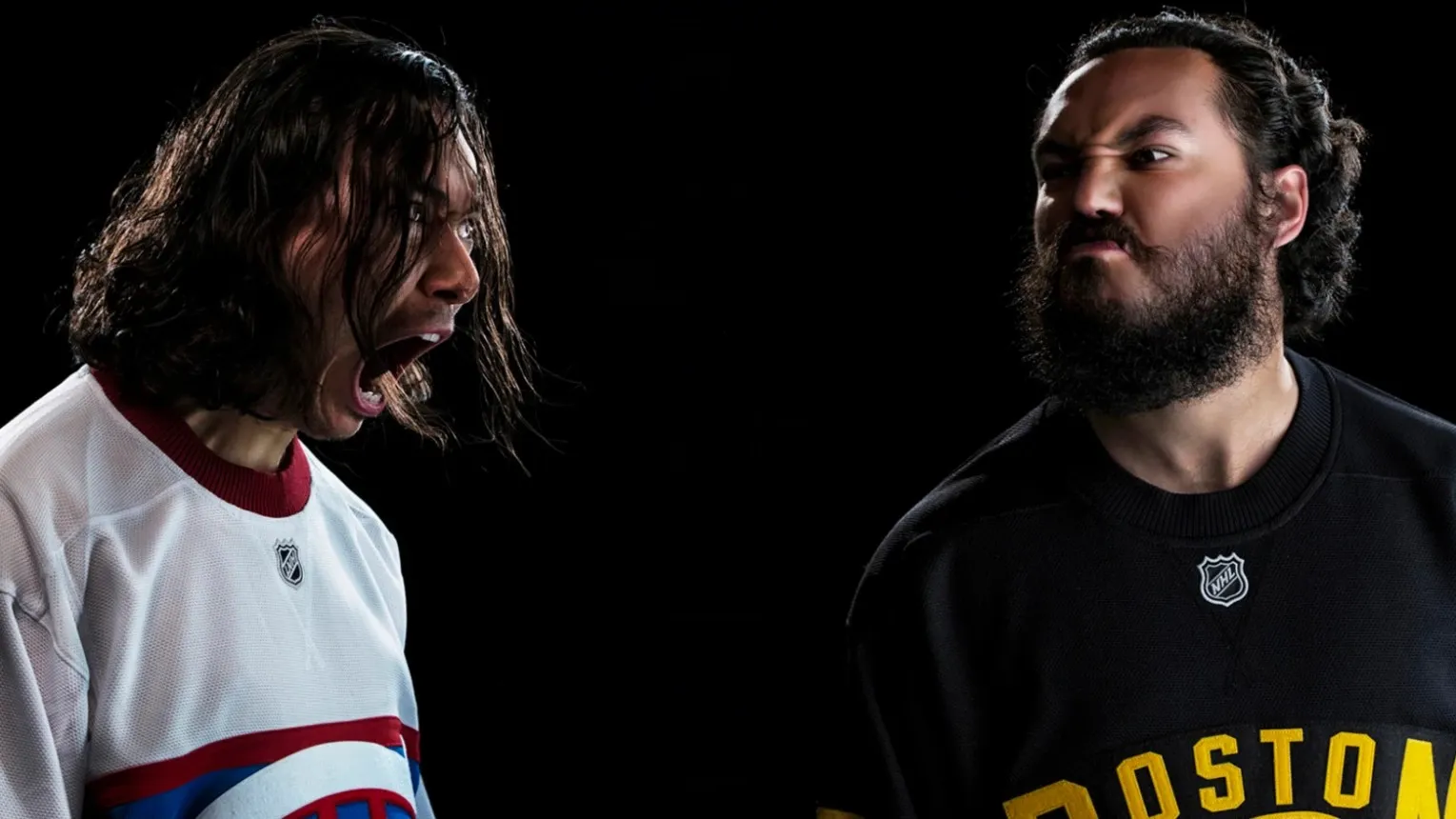 Two hockey fans face off on a black background: one in a white Canadiens jersey roaring, the other in a black Boston jersey scowling back.